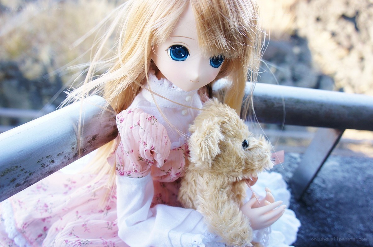 doll with teddy bear outdoors