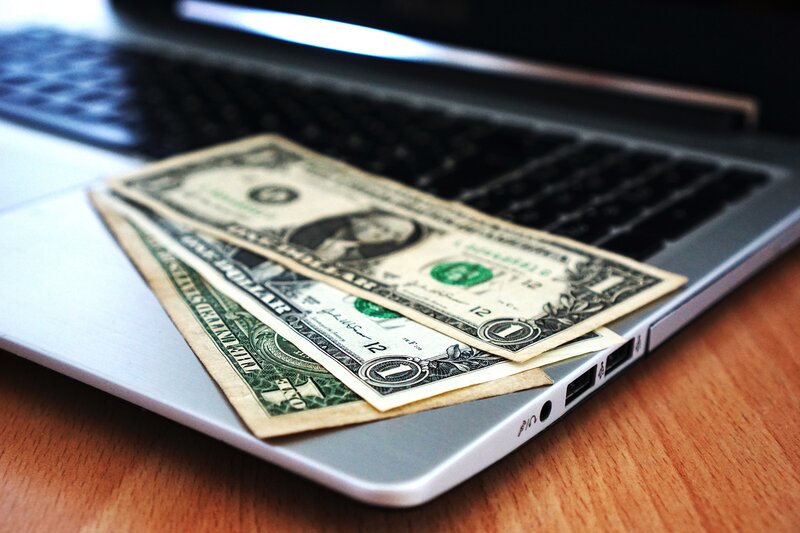 Dollar bills on laptop