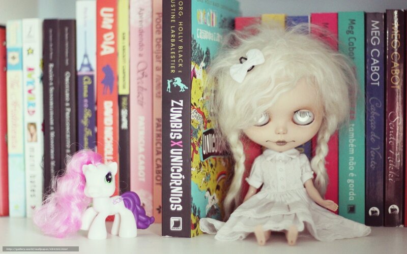 Dolls in front of books