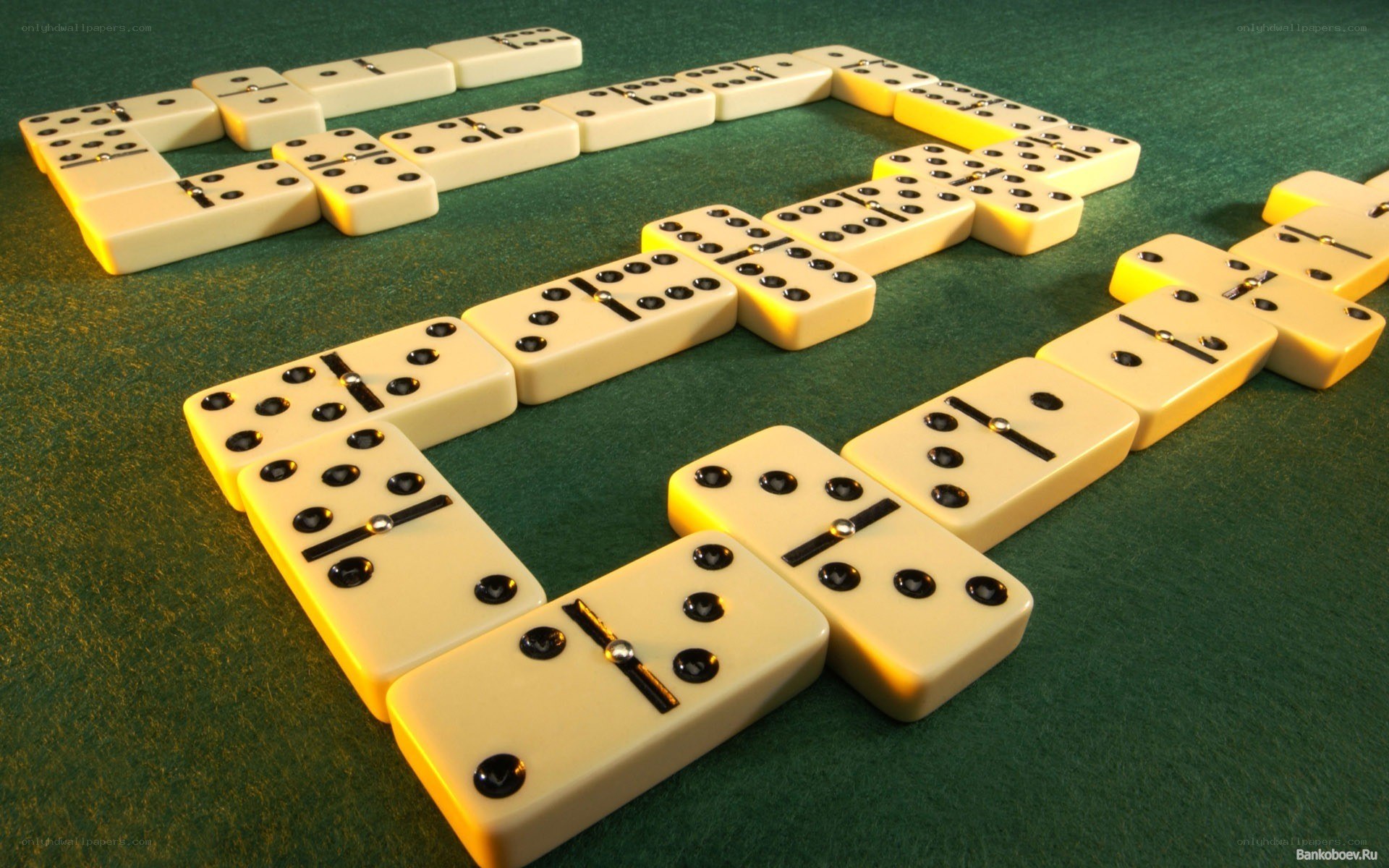 Dominoes arranged on green table