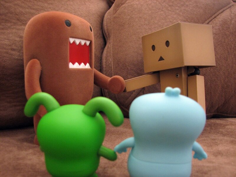 Domo and Danbo toys on a couch