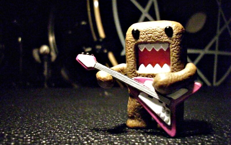 Domo Figure Playing Guitar