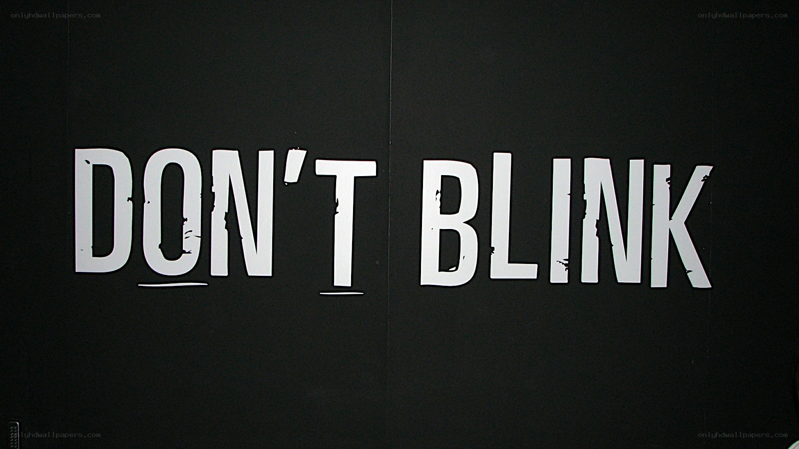 Don't Blink text on black wall