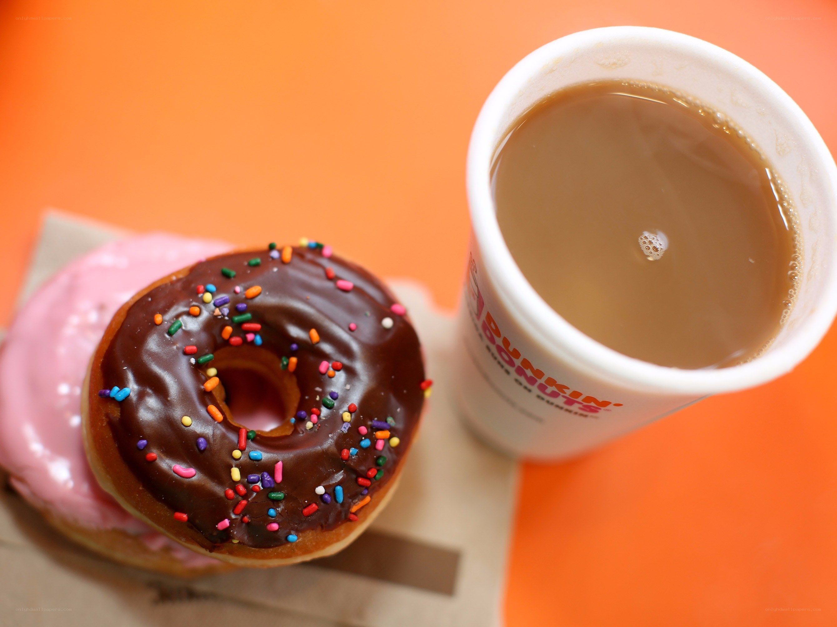 donut and coffee on orange
