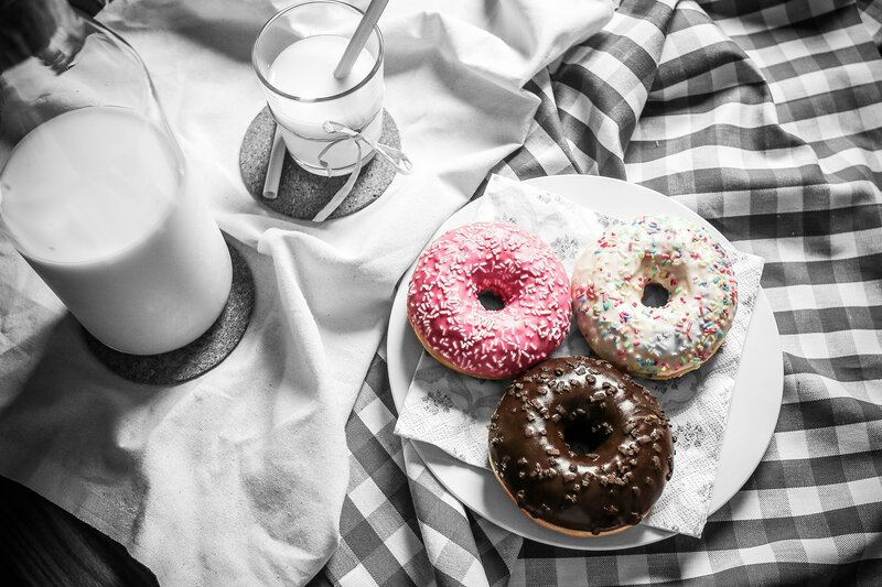 donuts and milk on checkered cloth