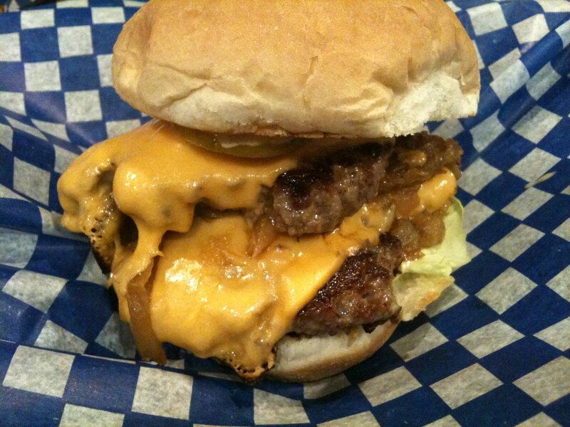 Double cheeseburger on checkered paper