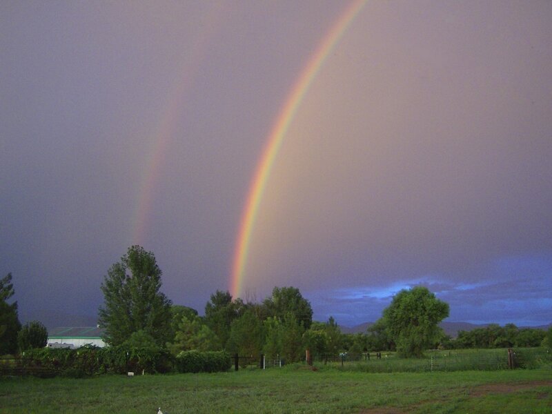Double rainbow over a farm