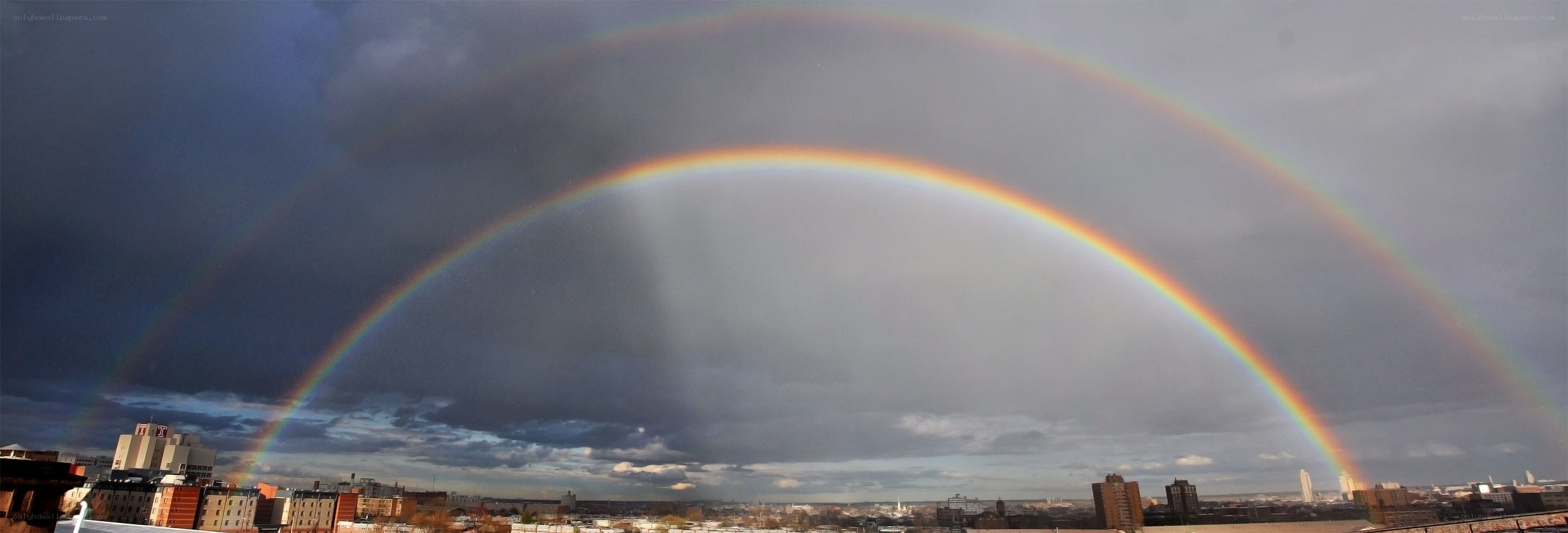 Double rainbow over city