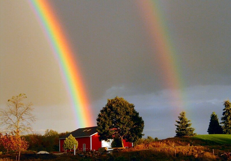 Double rainbow over red barn