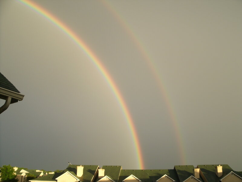 Double rainbow over rooftops