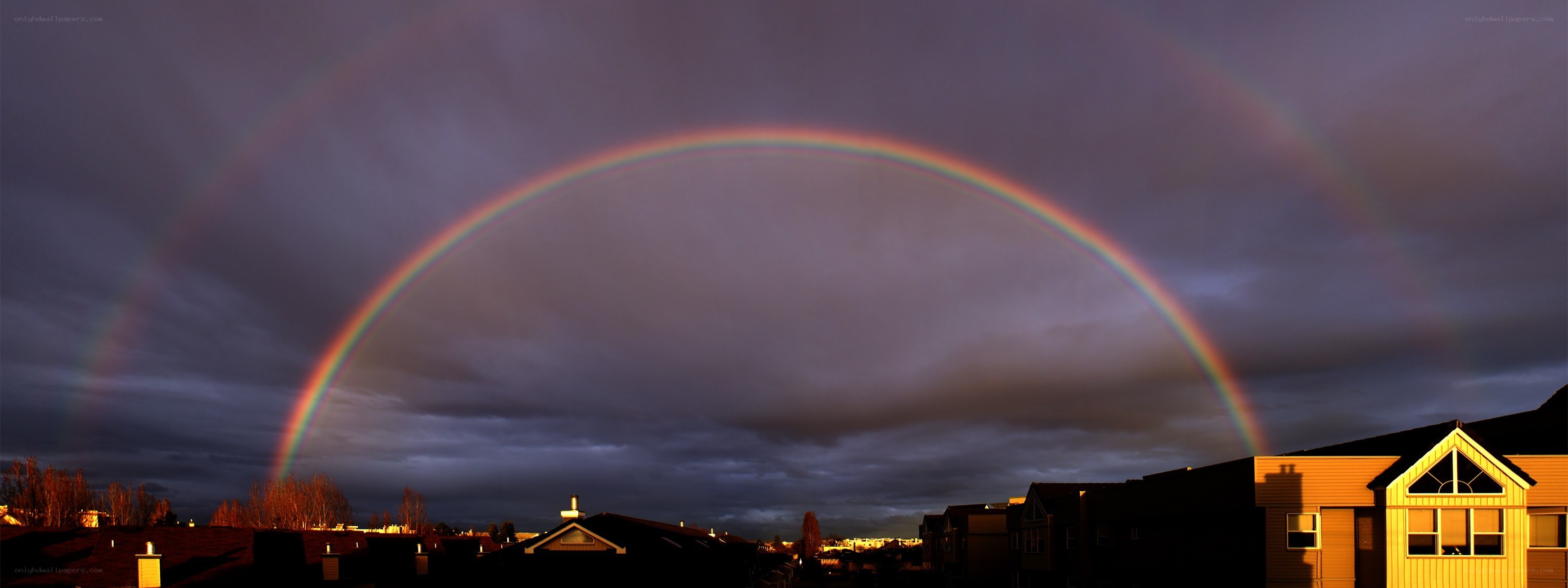 Double rainbow over suburban homes