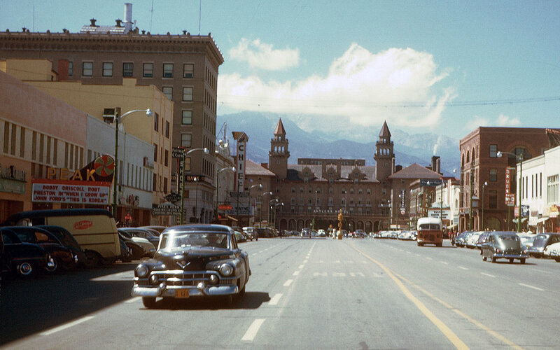 Downtown street with mountains in background