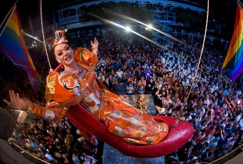Drag queen in giant shoe at parade