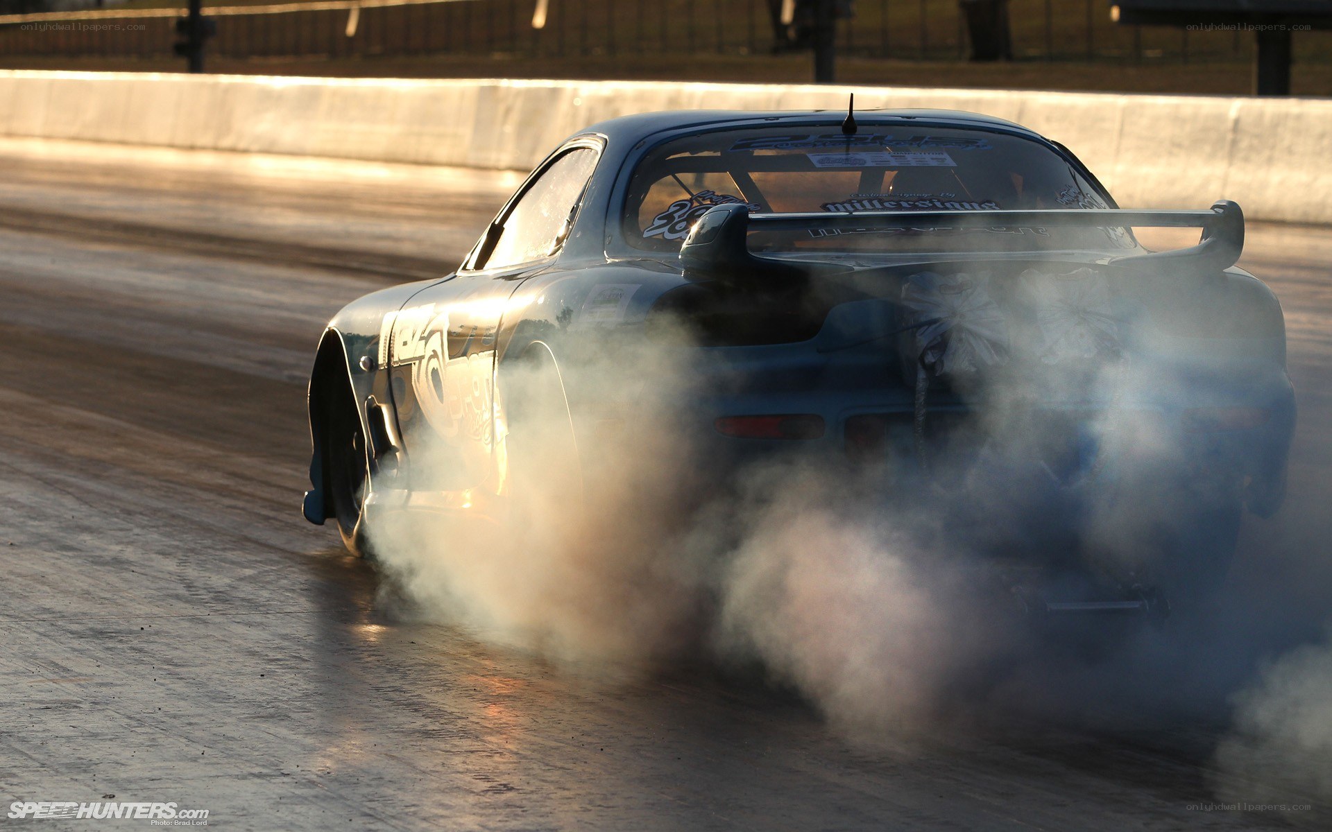 Drag racing car burning rubber
