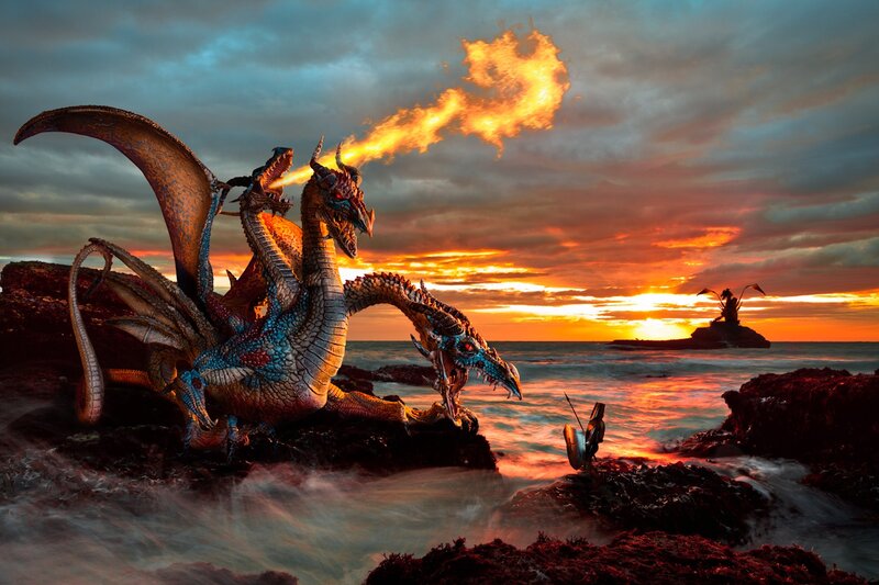 Dragon breathing fire on a beach
