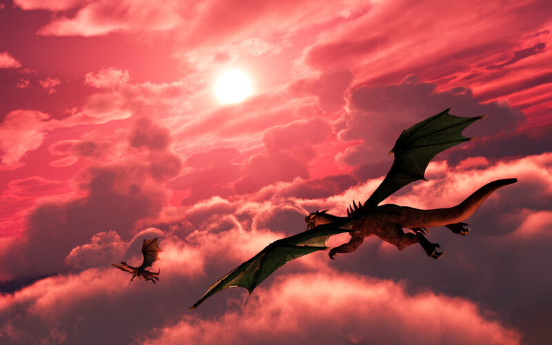 Dragons flying at sunset