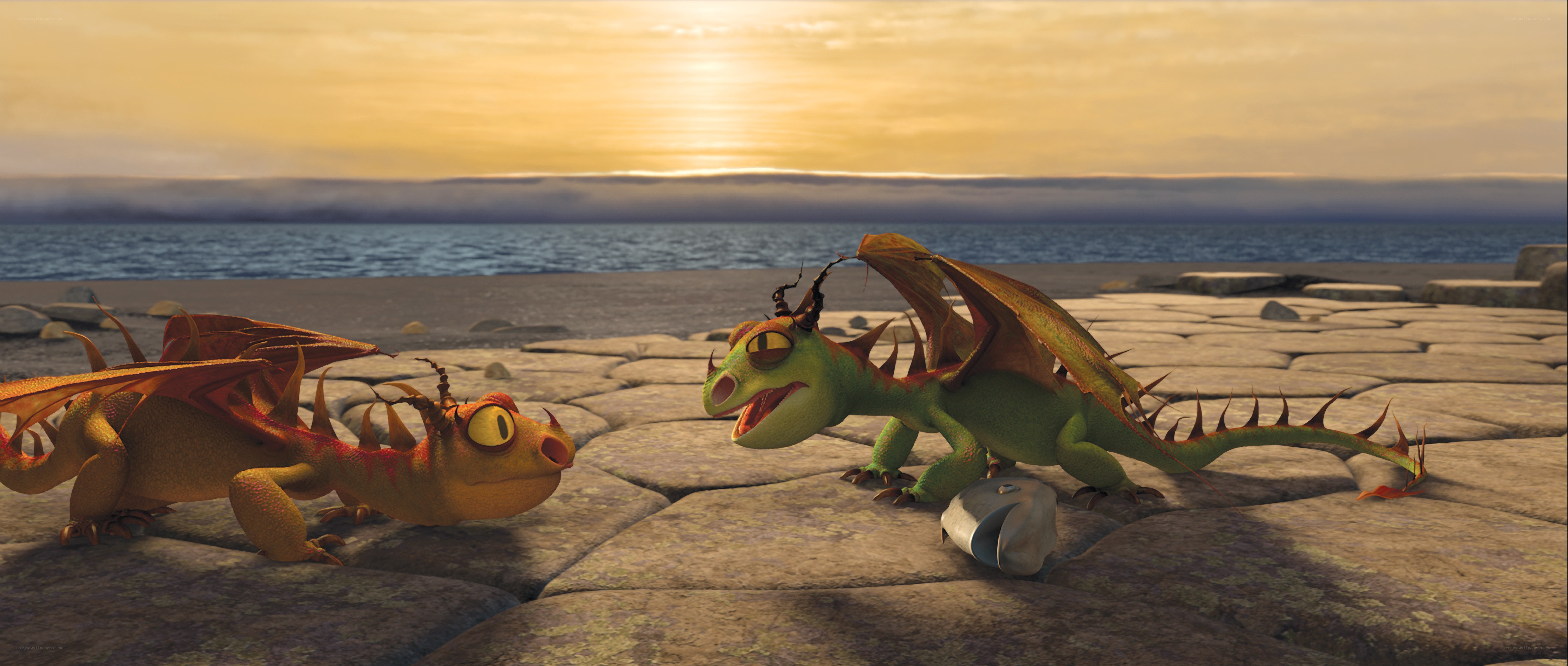 Dragons on a beach at sunset
