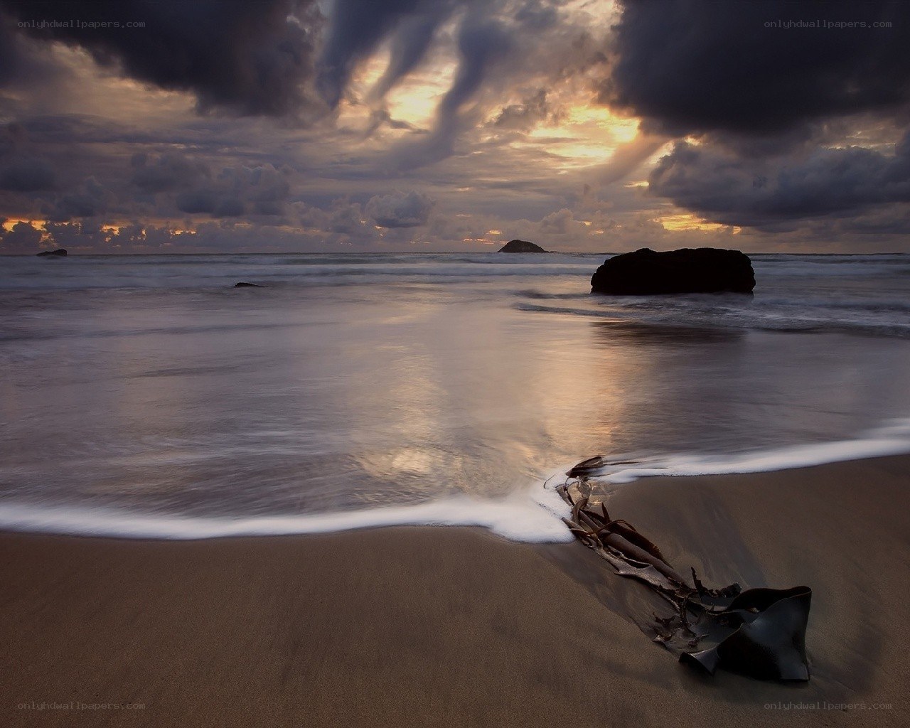Dramatic beach sunset with storm clouds