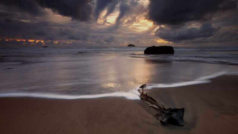 Dramatic beach sunset with storm clouds