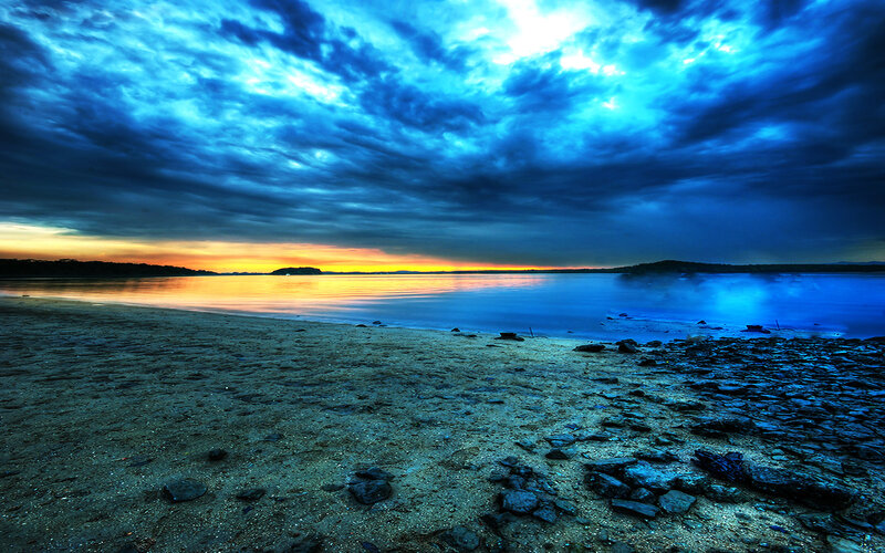 dramatic blue sky over calm water
