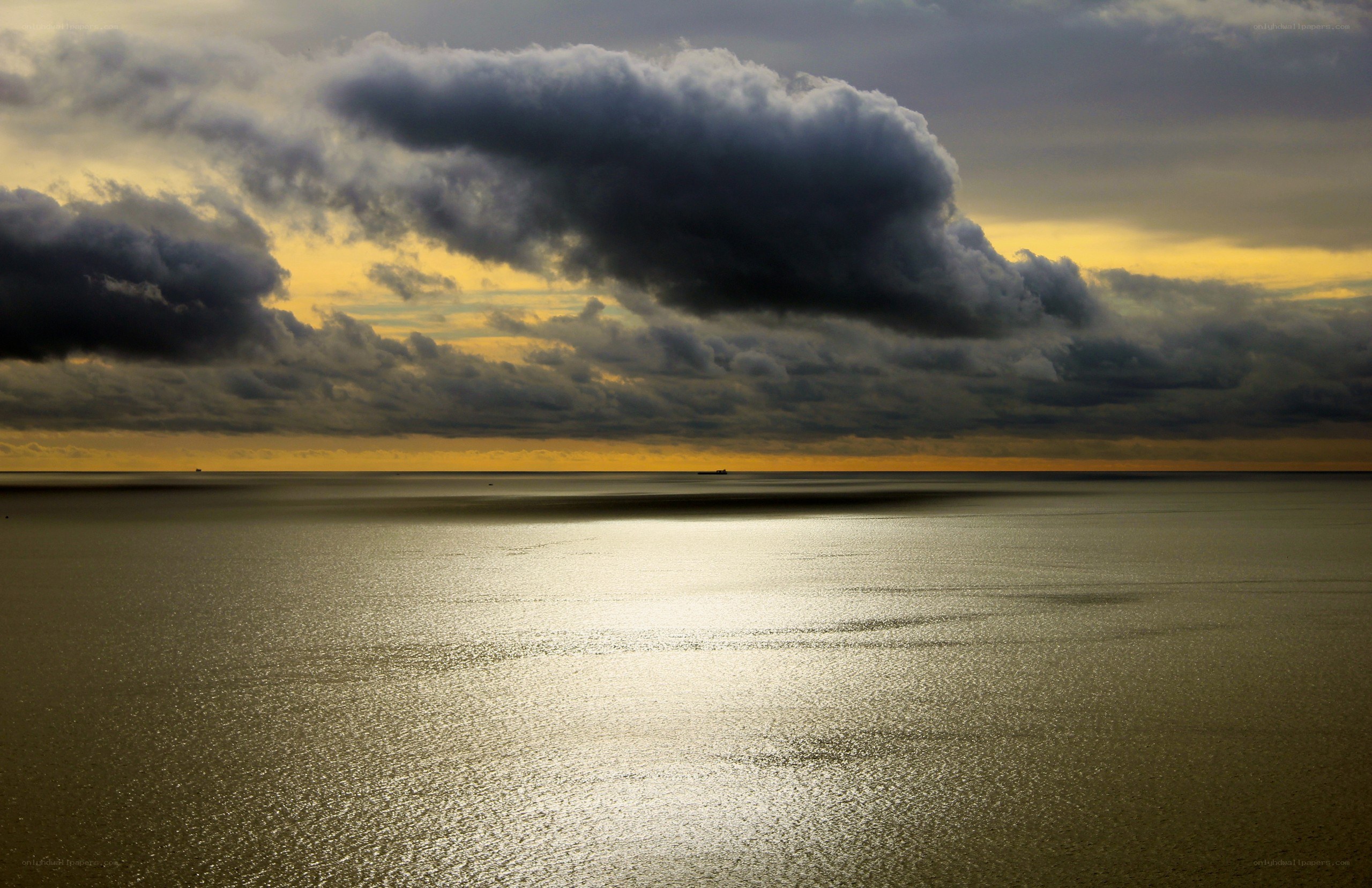 dramatic clouds over calm sea