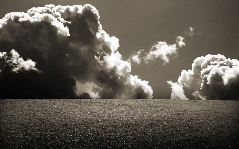 Dramatic Clouds Over Field