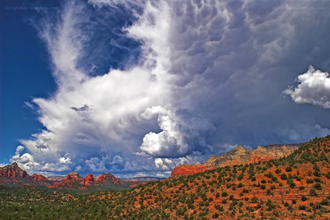 Dramatic clouds over red rock formations
