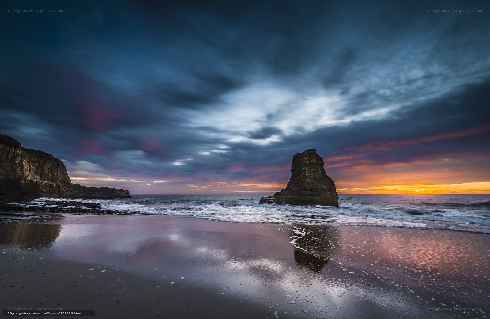 Dramatic coastal sunset with rock formations