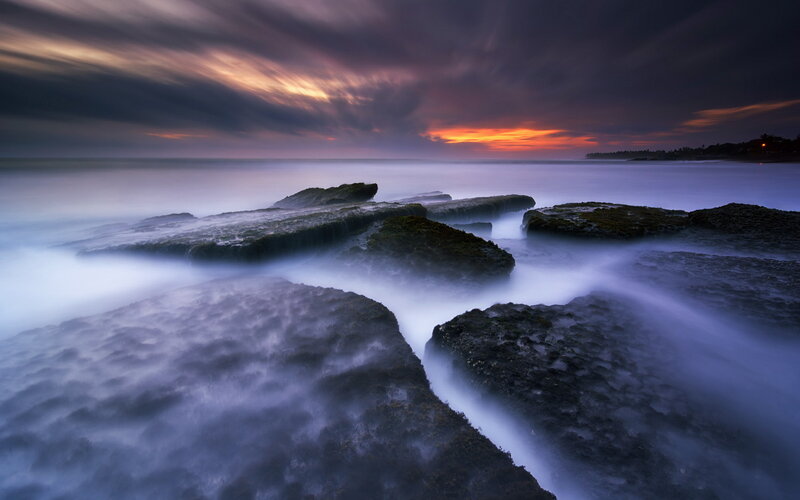Dramatic coastal sunset with rocks
