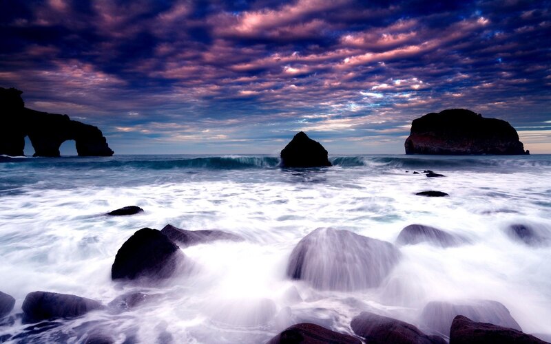 Dramatic coastal sunset with sea arch