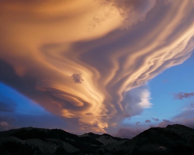 Dramatic lenticular clouds over mountains