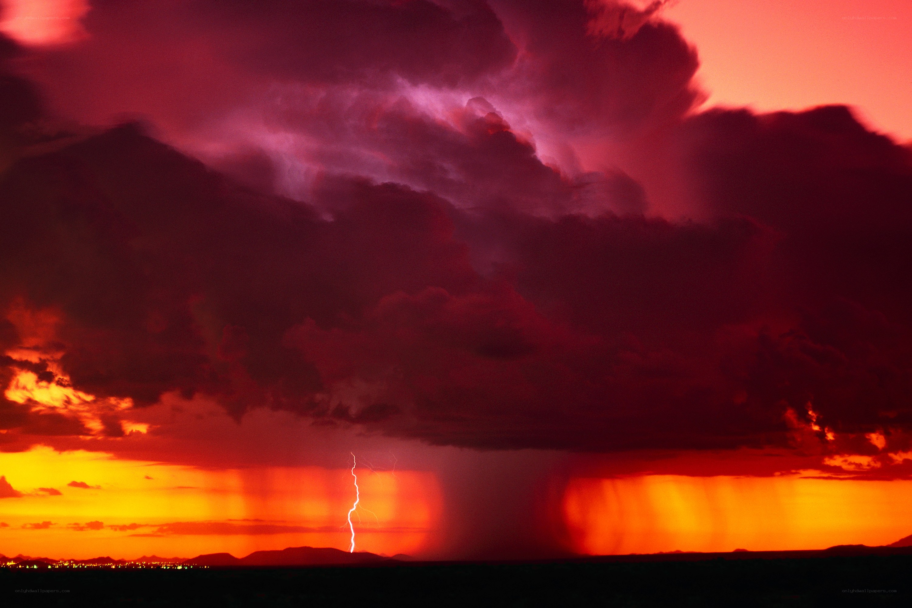 Dramatic lightning storm at sunset