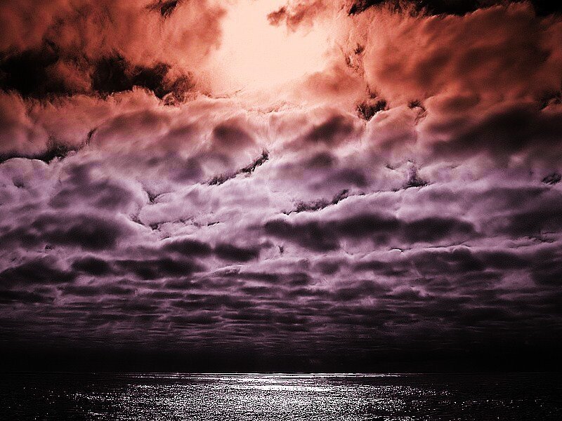 dramatic purple sky over water