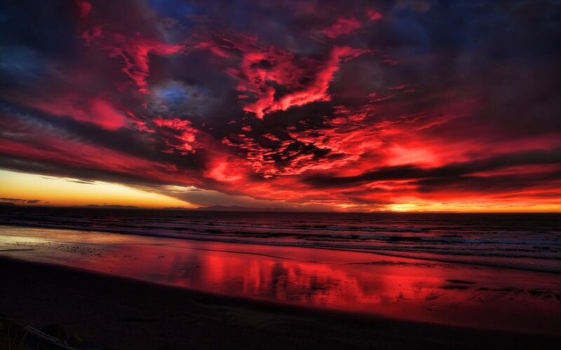 dramatic red sunset over beach