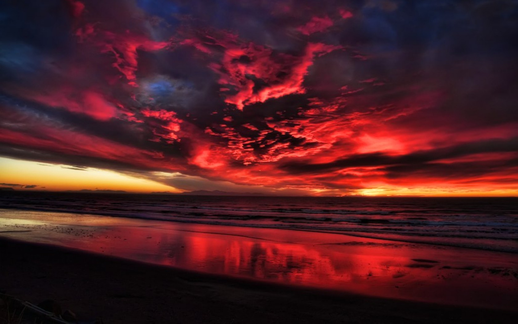 dramatic red sunset over beach