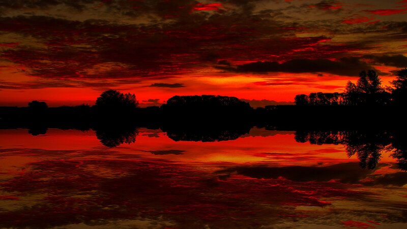 dramatic red sunset over water
