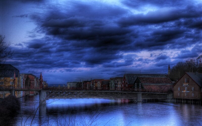 Dramatic sky over a riverside town