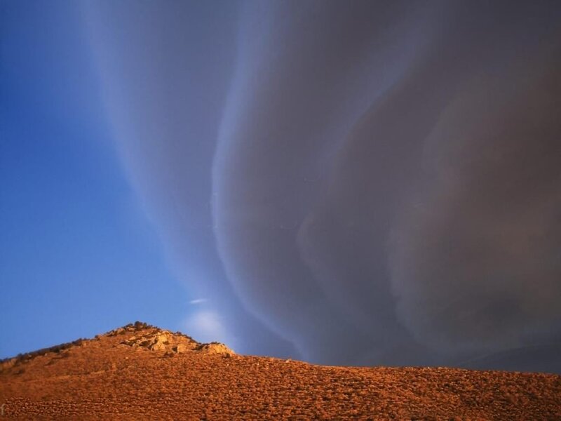 dramatic sky over desert hill
