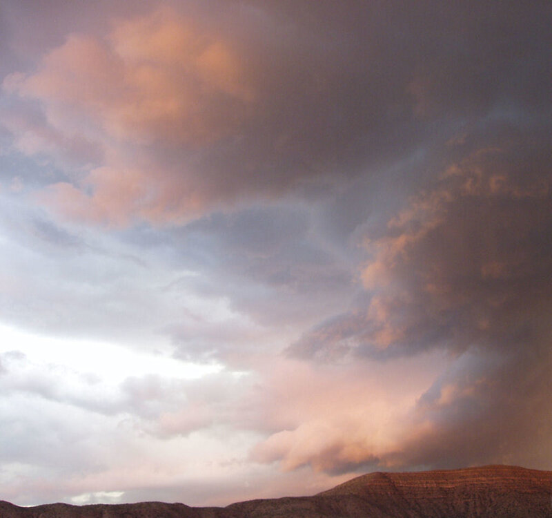 dramatic sky over desert hills