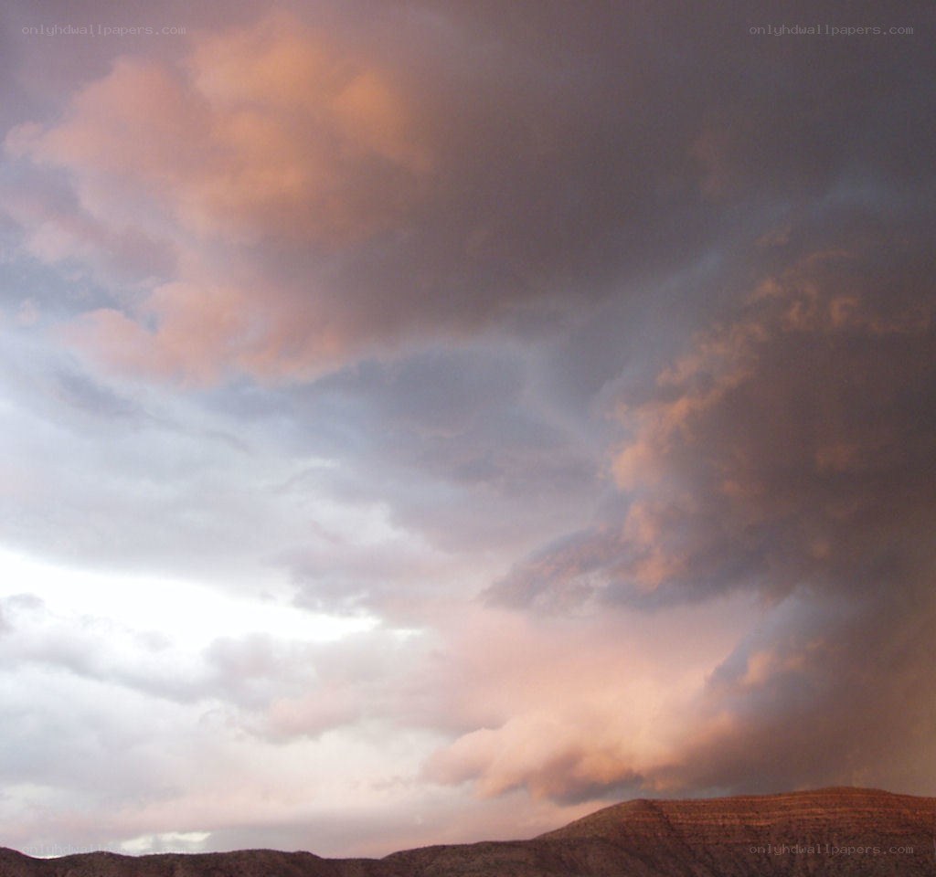 dramatic sky over desert hills
