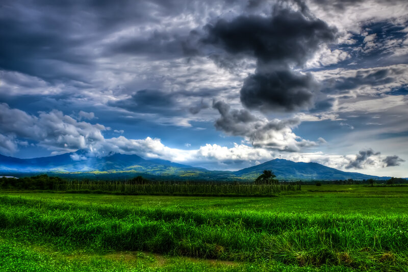 Dramatic sky over green fields