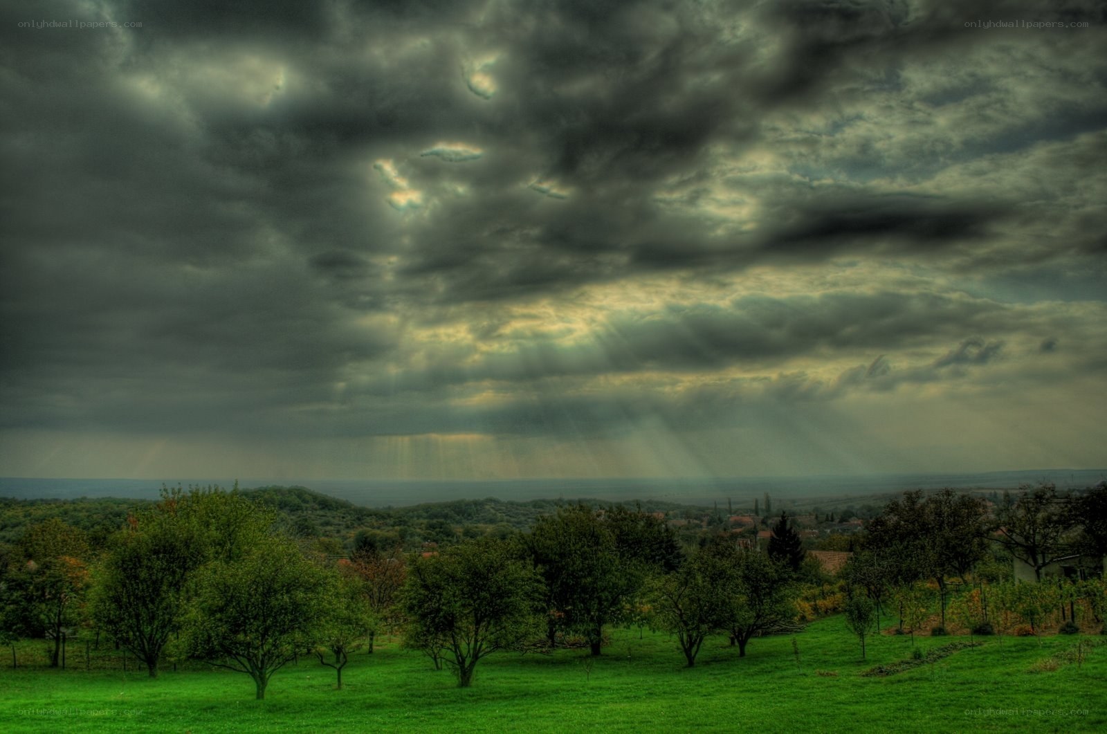 Dramatic sky over green fields