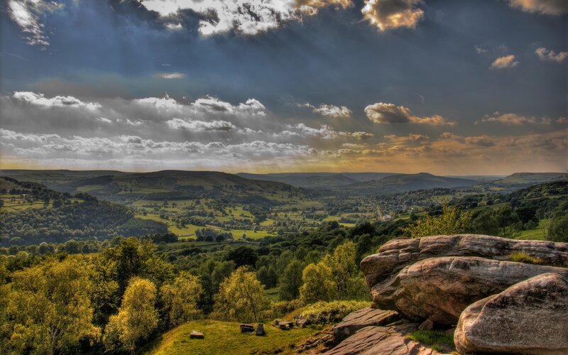 dramatic sky over green hills