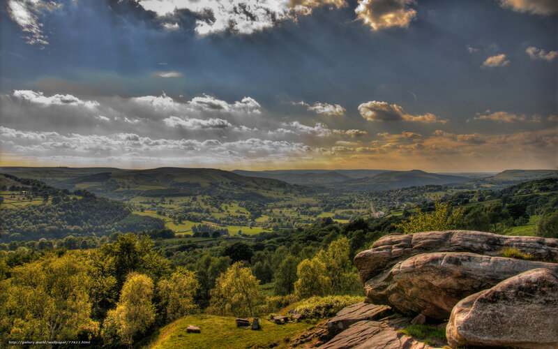dramatic sky over green hills