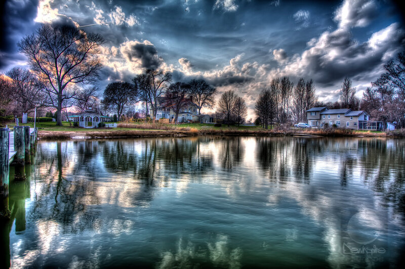 Dramatic sky over lakeside homes