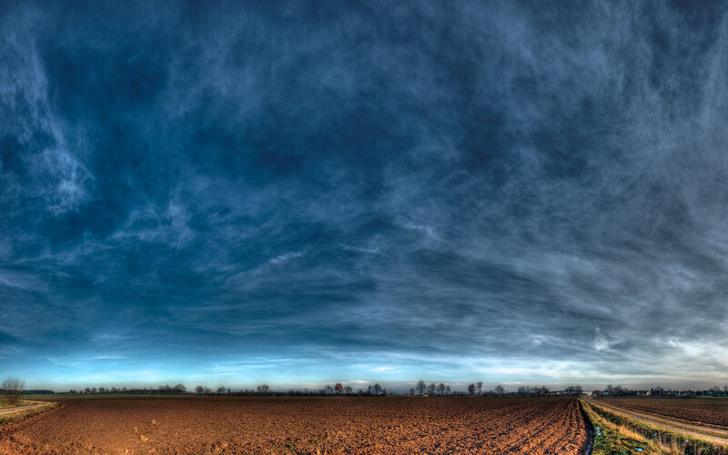 Dramatic sky over plowed field