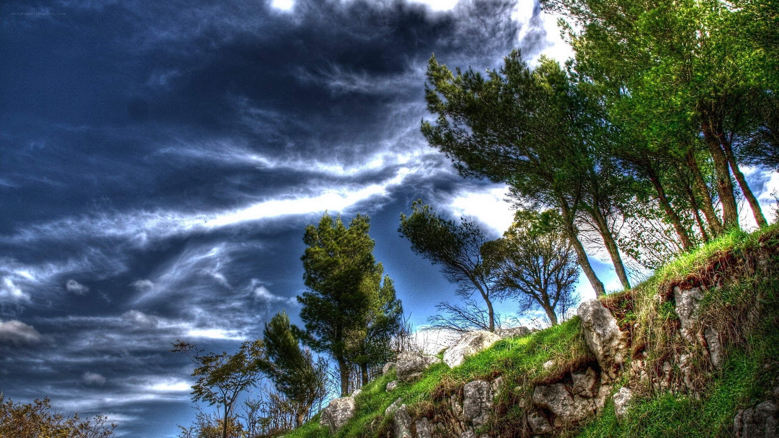 Dramatic sky over rocky hill