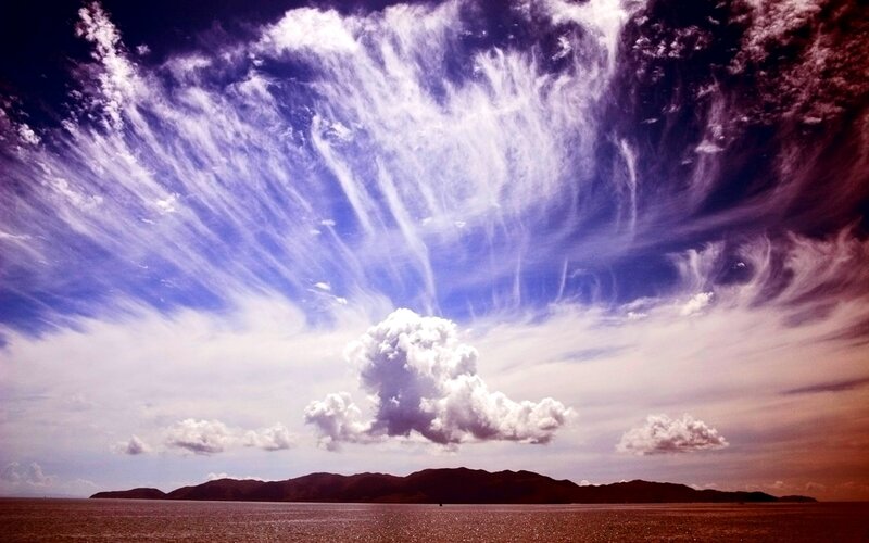 dramatic sky over sea and mountains