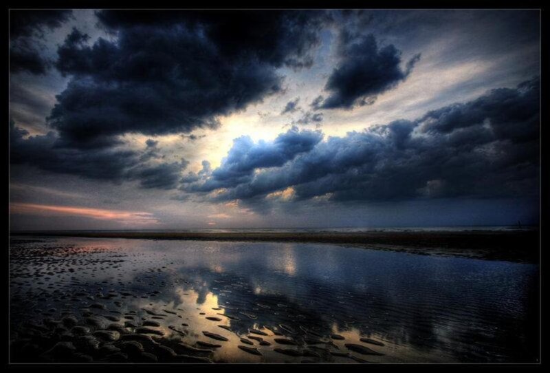 dramatic storm clouds over beach