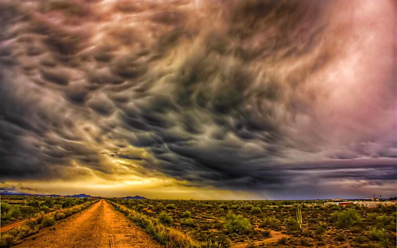 Dramatic storm clouds over desert road